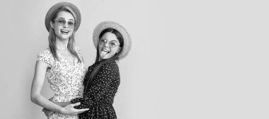 Mother and daughter kid banner, copy space, isolated background. glad mom and daughter in straw hat on yellow background