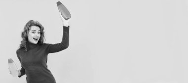 happy redhead lady curly dyed hair choosing body care product of shampoo having fun, beauty product