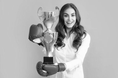 Woman in boxing gloves hold champion winner cup, trophy. Excited win woman in boxing gloves. Winning success power woman. Girl smiling and screaming for success. Celebration concept