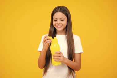 Child teen with water bottle isolated studio background. Water bottle and healthy life. Health and water balance. Happy teenager portrait. Smiling girl