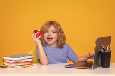 School child using laptop computer. Nerd pupil. Clever child from elementary school with book. Smart genius intelligence kid ready to learn