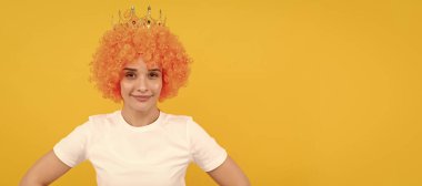 Party fun wig. cheeful freaky selfish woman in curly clown wig and queen crown for party, joy. Woman isolated face portrait, banner with copy space