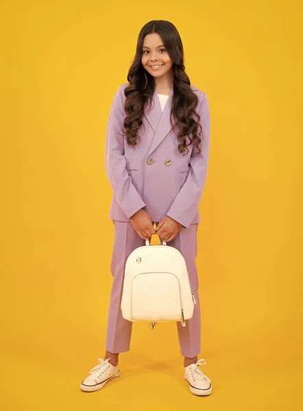 stock image Back to school. Fashion teenage school girl ready to learn. School children on yellow isolated background. Happy face, positive and smiling emotions of teenager girl