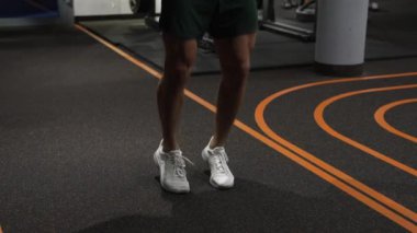 athlete skipping with jump rope. Sport and exercising people. Active sport workout. Workout of man legs in gym. fit and active sportsman skipping rope. Best cardio workout. leaps off the ground.