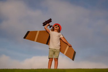 Children day. Dream of flying. Little children with toy airplane in a field at sunset. Success and child leader concept. Boy dreams of becoming a pilot