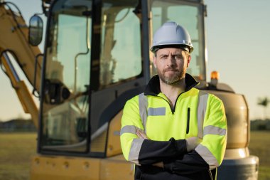 Worker at building site. Construction manager in helmet. Male construction engineer. Architect at a construction site. Handyman builder in hardhat. Building concept. Builder foreman