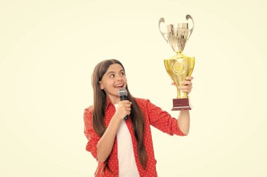 Teenage girl holding a trophy microphone speech. Kid winner child won the competition, celebrating success and victory, achievement award