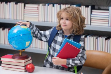 Child from elementary school with book. Little student, clever nerd pupil ready to study. First time to school. Concept of education and learning