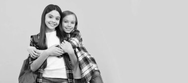 School girls friends. concept of education. kids with long hair on yellow background. Banner of schoolgirl student. School child pupil portrait with copy space