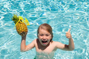 Child playing in the swimming pool. Summer kids activity