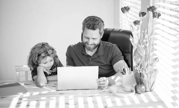 boy do homework with private tutor. webinar video lesson. online education on laptop. homeschooling and elearning. back to school. father and son use communication technology at home. family blog.