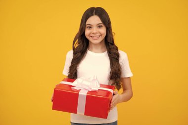 Child with gift present box on isolated background. Presents for birthday, Valentines day, New Year or Christmas. Happy teenager, positive and smiling emotions of teen girl