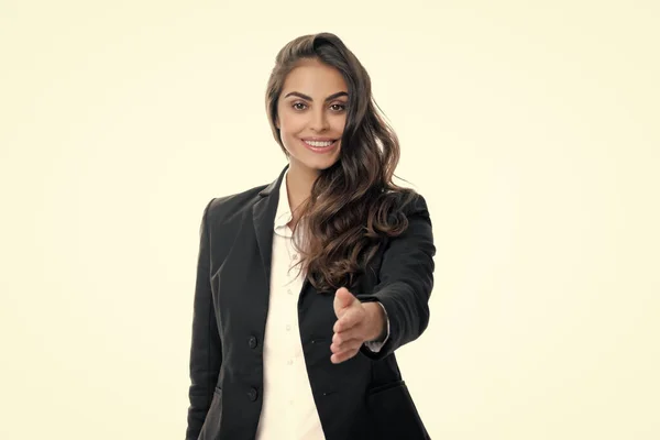 Business woman in suit smiling friendly offering handshake as greeting and welcoming. Successful business. Businesswoman giving a handshake. Friendly offering handshake as greeting and welcoming
