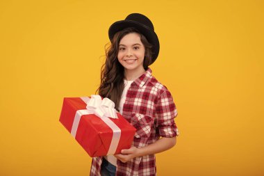 Teenager child with gift box. Present for holidays. Happy birthday, Valentines day, New Year or Christmas. Kid hold present box. Happy teenage girl, positive and smiling emotions