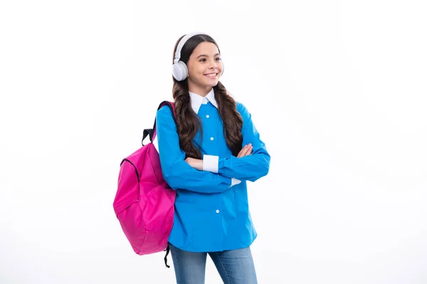 Stock image School teenager child girl in headphones with school backpack. Teenager student, isolated background. Learning music