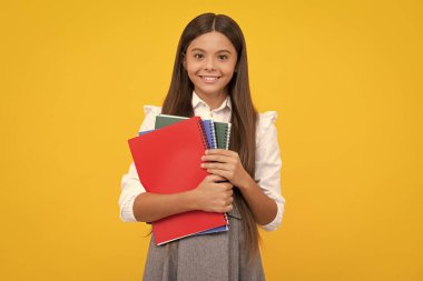 Teenager school girl with books isolated studio background. Happy girl face, positive and smiling emotions