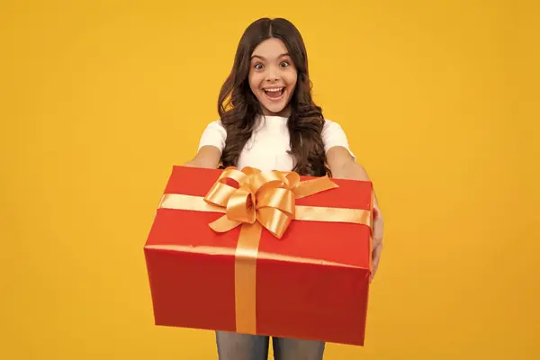 stock image Amazed teenager. Portrait of teenager child girl 12, 13, 14, years old holding Christmas gift box. Teen giving birthday gift. Excited teen girl