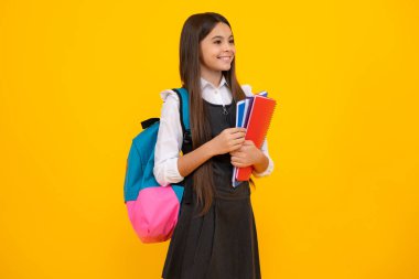 School teenager child girl with school backpack hold book and copybook. Teenager student, isolated background. Learning and knowledge. Go study
