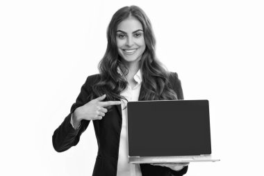 Beautiful smiling business woman over grey background using laptop computer. Woman holding laptop with empty mock up screen for copy space