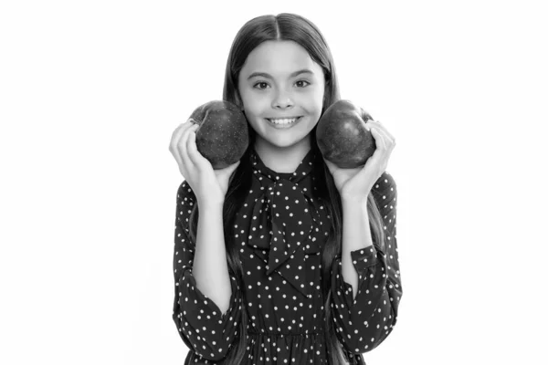 stock image Child girl eating an apple over isolated white studio background. Tennager with fruit. Portrait of happy funny smiling teenage child girl