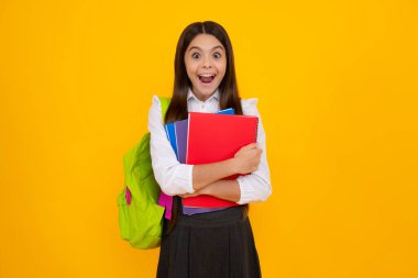 Amazed teen girl. School teenager child girl 12, 13, 14 years old with school bag book and copybook. Teenager schoolgirl student, isolated background. Learning and knowledge. Excited expression