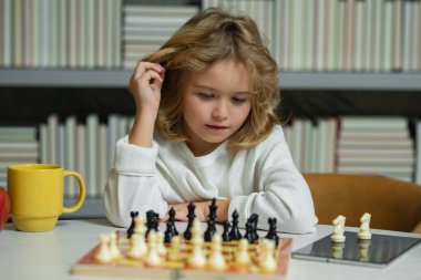 Little child chessman play chess game, checkmate