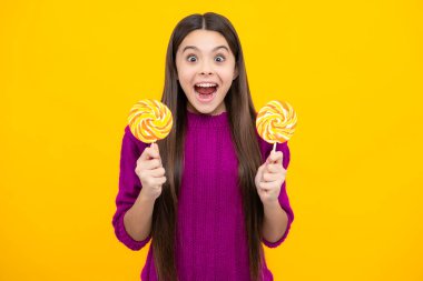 Excited face. Teenage girl with lollipop, child eating sugar lollipops, kids sweets candy shop. Amazed expression, cheerful and glad