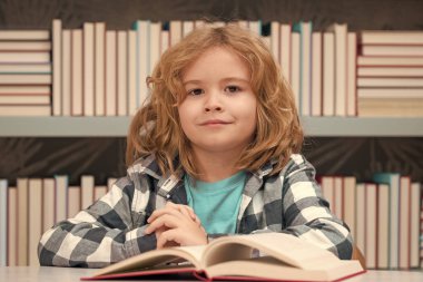 Child reading book in a book store or library