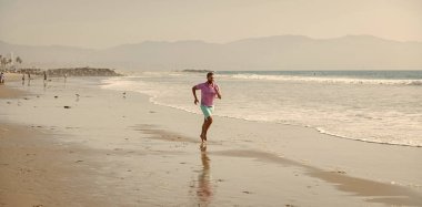 sport athletic man running on summer beach for training, freedom.