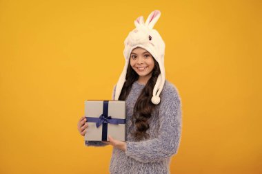 Teenager child with gift box. Present for holidays. Happy birthday, Valentines day, New Year or Christmas. Kid hold present box. Happy teenage girl, positive and smiling emotions