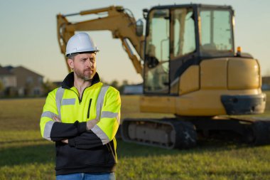 Worker at building site. Construction manager in helmet. Male construction engineer. Architect at a construction site. Handyman builder in hardhat. Building concept. Builder foreman