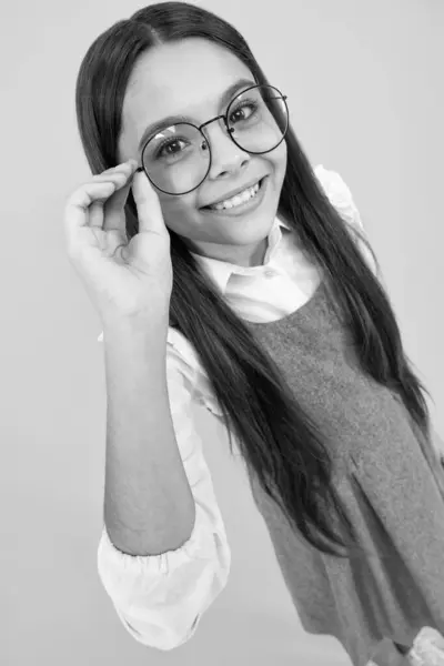 stock image Portrait of teenager child in glasses. Kid at eye sight test. Girl holding eyeglasses and looking at camera. Vision, eyesight measurement for school children