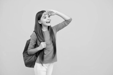 Happy teenager portrait. School teen girl in with backpack. Teenager student on isolated background. Kids learning, education, studying and knowledge. Smiling girl