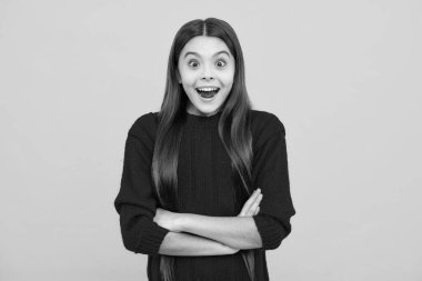Shocked teenager child with amazed look on yellow background, amazement. Excited kids face. Amazed expression, cheerful and glad