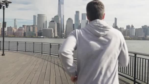 纽约的城市景观与运动员男子跑到户外 体育运动的日常活动 曼哈顿的观点与男子赛跑选手训练 在纽约市跑步的运动运动员 选择焦点和复制空间 — 图库视频影像