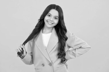 Happy face, positive and smiling emotions of teenager girl. Emotional portrait of caucasian teenager child girl isolated on studio yellow background