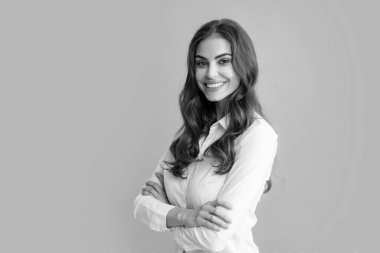 Happy smiling woman portrait. Attractive young pretty cheerful girl in casual clothing feeling happy and carefree, isolated gray background