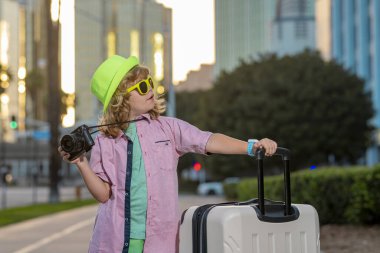 Child boy and travel Suitcase. Kid and Luggage Packed for vacation, child trip. Little tourist with travel bag. Child traveler and baggage. Kid with luggage bags going on holiday trip