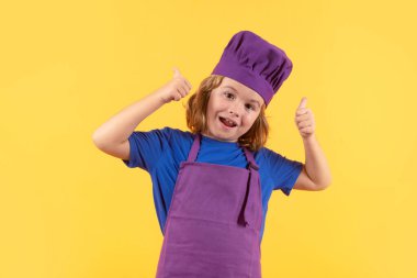 Chef child preparing healthy food. Studio portrait of child with chef hats