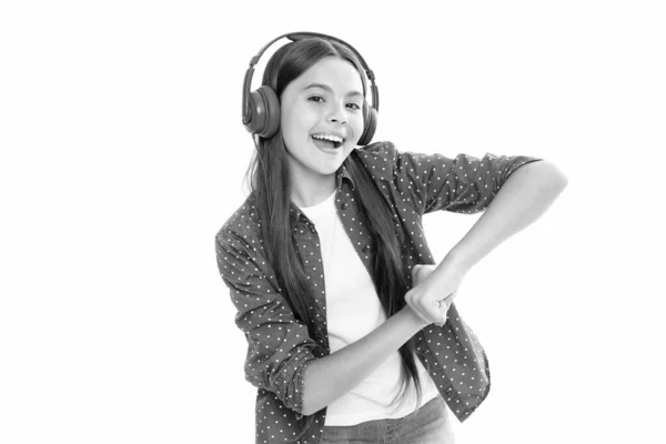 stock image Funny kid girl 12, 13, 14 years old listen music with headphones. Teenage girl with headphones listening songs on headset earphone. Portrait of happy smiling teenage child girl