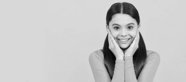 happy teen girl with long hair on yellow background. Child face, horizontal poster, teenager girl isolated portrait, banner with copy space