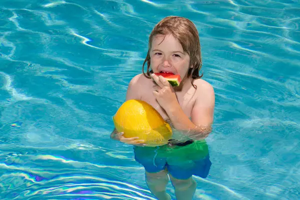 Child in swimming pool playing in summer water. Vacation and traveling with kids