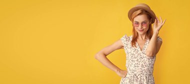 Woman isolated face portrait, banner with copy space background. smiling woman in straw hat and sunglasses on yellow