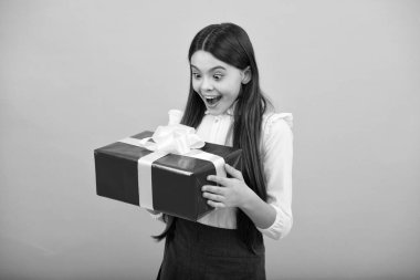 Hediye kutusu olan ergen bir çocuk. Tatil hediyesi. Mutlu yıllar, Sevgililer Günü, Yeni Yıl ya da Noel. Çocuk hediye kutusunu tut. Genç kızın şaşırmış duyguları.