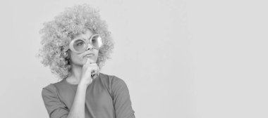 let me think. happy childhood. going crazy. fancy party look. kid in curly clown wig. Funny teenager child in wig, party poster. Banner header, copy space