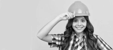 happy kid with curly hair in construction helmet, architect. Child builder in helmet horizontal poster design. Banner header, copy space