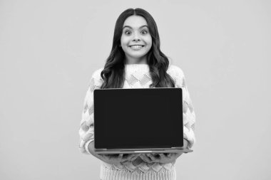 School student using laptop. E-learning and online education. Screen of laptop computer with copyspace mockup. Teen girl on internet video chat isolated on isoalted studio background