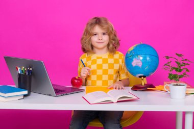 School child. Kid boy from elementary school. Pupil go study. Clever schoolboy learning isolated on pink red studio background. Kids study, knowledge and education