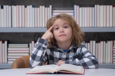 Child reading book in a book store or library