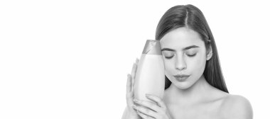 young lady hold body lotion bottle isolated on white background with copy space, keratin. Woman beauty face, close up portrait, isolated banner with copy space